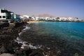 PLAYA BLANCA, LANZAROTE - JUIN 9. 2019: View on cityscape with promenade at ocean in lagoon with white houses