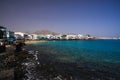 PLAYA BLANCA, LANZAROTE - JUIN 9. 2019: View on cityscape with promenade at ocean in lagoon with white houses