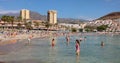 Playa de las Americas, Tenerife, Spain - February 16, 2024: people relaxing and swimming on Playa de las Vistas