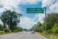 Playa del Carmen, Mexico - January 10, 2018: Informative sign with white letters in a green structure lin a highway