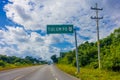 Playa del Carmen, Mexico - January 10, 2018: Informative sign with white letters in a green structure lin a highway