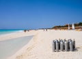 Playa del Carmen, Mexico - March 23, 2010: Several scuba diving tanks stacked on the beach to be used by a group of tourists who