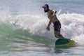 Playa del Carmen, Mexico May 9, 2023: Man enjoying his board surfing the waves of the warm and beautiful Caribbean Sea.