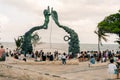 PLAYA DEL CARMEN, MEXICO - may 2023 Visitors mingling with performers under the Portal Maya sculpture.
