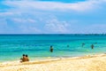 Tropical Caribbean beach people parasols fun Playa del Carmen Mexico