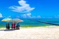 Tropical Caribbean beach people parasols fun Playa del Carmen Mexico