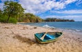 PLAYA MONTEZUMA, COSTA RICA, JUNE, 28, 2018: Outdoor view of small boat in the sand with some trees behind in Playa