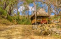 PLAYA MONTEZUMA, COSTA RICA, JUNE, 28, 2018: Outdoor view of thatched roof over sandy beach and gorgeous blue sky in