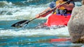 Playboating. A man sitting in a kayak with oars in his hands performs exercises on the water