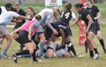 Player Being Tackled in Women's Rugby Match