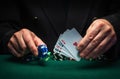 The player bets on a winning combination four of a kind or quads in poker game on a green table with chips and money in a club Royalty Free Stock Photo