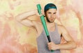 Player with confident face plays baseball. Sports and baseball training concept. Guy in grey tank top Royalty Free Stock Photo