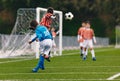 Player Cross a Football Soccer Ball. Boys Playing Football Game on Stadium Pitch Royalty Free Stock Photo