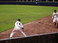 Player dig ball out of dirt and sets to throw