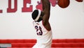 Player dunking the ball during a high school basketball game Royalty Free Stock Photo