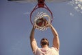 player dunking basketball ball through net ring with hands, sport motivation Royalty Free Stock Photo