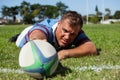 Player holding rugby ball on goal post line