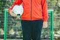 Player holding soccer football with face mask for sports during covid-19 pandemic Royalty Free Stock Photo