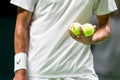 Player holding tennis balls before serving Royalty Free Stock Photo