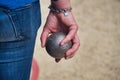 A player holds in hand a boule for petanque Royalty Free Stock Photo