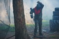 Player in paintball in gear and a game marker with his hands up leaves the court after hitting. Royalty Free Stock Photo