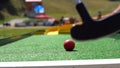 player play mini golf with red ball Royalty Free Stock Photo