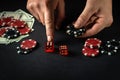 The player points his finger at the maximum in the winning combination when playing craps in a poker club. Luck or luck in the