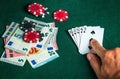 Player points with his finger at a winning flush combination in poker game on a table with chips and money in a casino Royalty Free Stock Photo