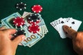 Player points with his finger at a winning flush combination in poker game on a table with chips and money in a casino Royalty Free Stock Photo