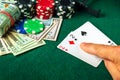 Player points with his finger at a winning one pair combination in a poker game on a table with chips and money in a casino Royalty Free Stock Photo