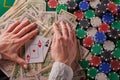 A player in a poker casino put a pair of aces on the background of chips and money of dollars. Victory, success. Gaming business Royalty Free Stock Photo
