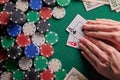 A player in a poker casino shows a pair of aces against the background of chips and money of dollars. Victory, success. Gaming Royalty Free Stock Photo