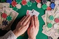 A player in a poker casino shows a pair of aces against the background of chips and money of dollars. Victory, success. Gaming Royalty Free Stock Photo