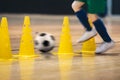 Player Practicing Indoor Soccer Dribbling Skills Running Between Yellow Training Cones