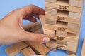 Player removing block from Jenga tower constructed