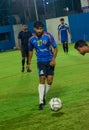 A player running with ball in a football match