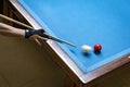 Player's arm holding cue above pool table. The player has just struck the white ball Royalty Free Stock Photo