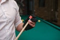 player& x27;s hand rubs the billiard cue with chalk close up