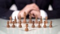 Player sacrificing pawn in chess game, startup company entering large market