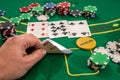 player shows two aces play card on a green table in a casino wirh chips. gambling Royalty Free Stock Photo