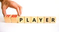 Player or teamplayer symbol. Businessman turns wooden cubes and changes concept words Player to Teamplayer. Beautiful white table Royalty Free Stock Photo