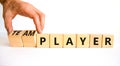 Player or teamplayer symbol. Businessman turns wooden cubes and changes concept words Player to Teamplayer. Beautiful white table Royalty Free Stock Photo