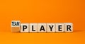 Player or teamplayer symbol. Turned wooden cubes and changed concept words Player to Teamplayer. Beautiful orange table orange Royalty Free Stock Photo