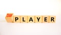 Player or teamplayer symbol. Turned wooden cubes and changed concept words Player to Teamplayer. Beautiful white table white Royalty Free Stock Photo