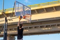 A player throws a ball into a basketball basket