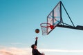 A player throws a ball into a basketball basket