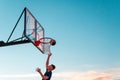 A player throws a ball into a basketball basket