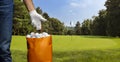 Player wearing a golf glove holding a bag full of golf balls. Sales concept Royalty Free Stock Photo