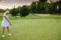 Player Woman Hit Ball Into Golf Tee . Royalty Free Stock Photo