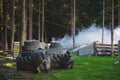 Players in paintball in gear and with a game marker on a special playing field with fortifications. Royalty Free Stock Photo